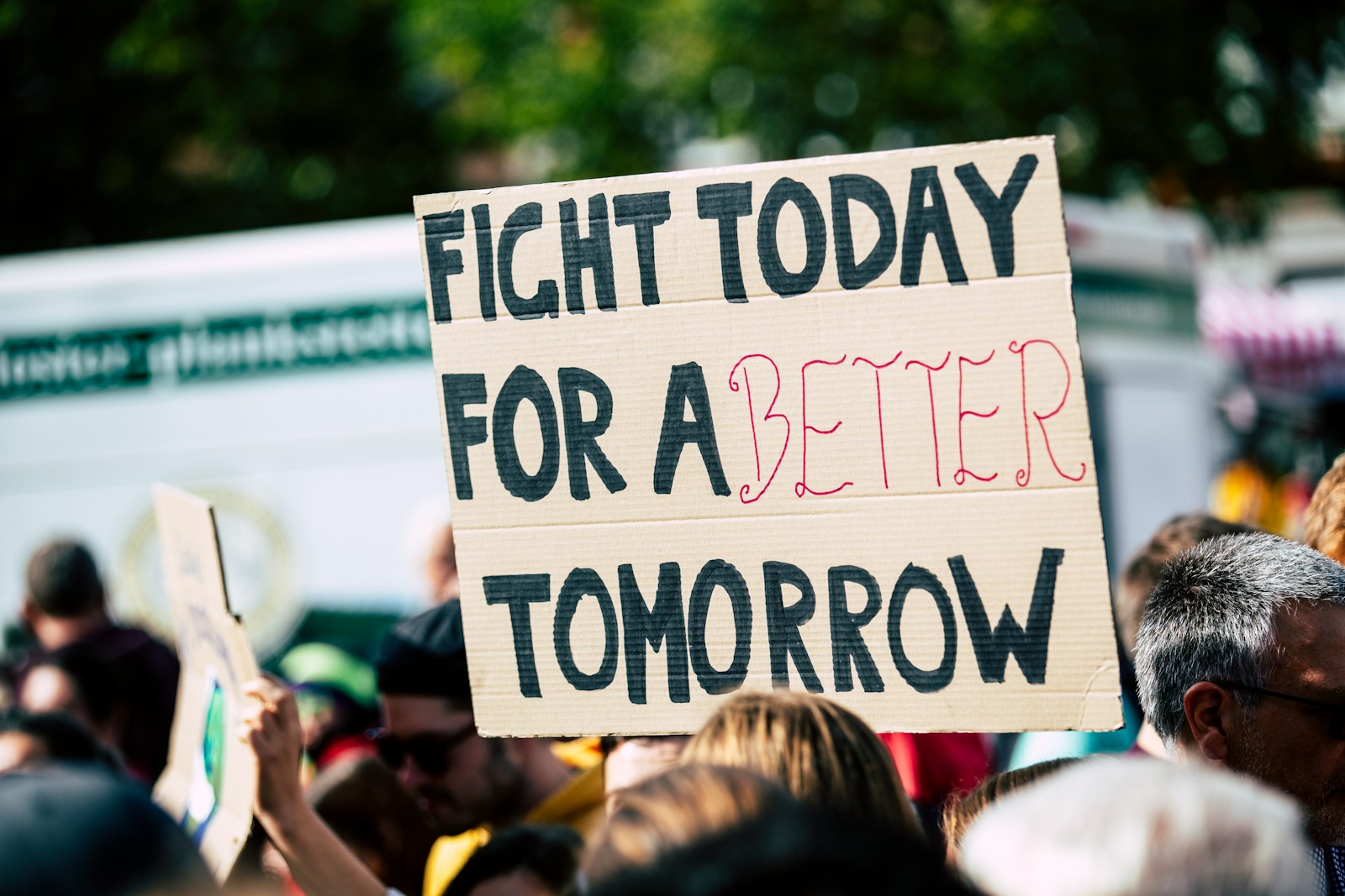 person holding fight today for a better tomorrow sign